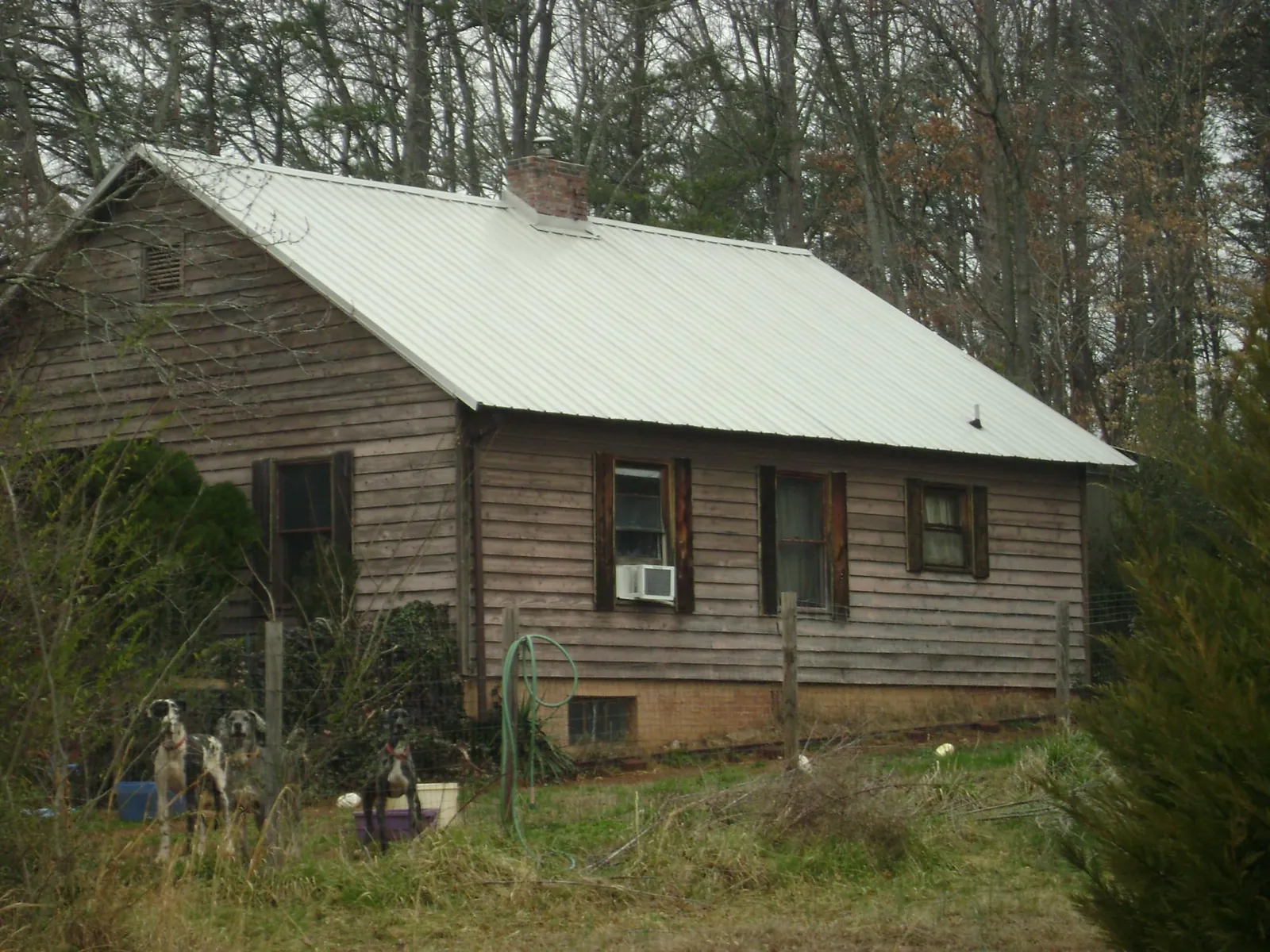 White metal roof on an old wood sided farmhouse, from a Metal Roof Installation job in Millport