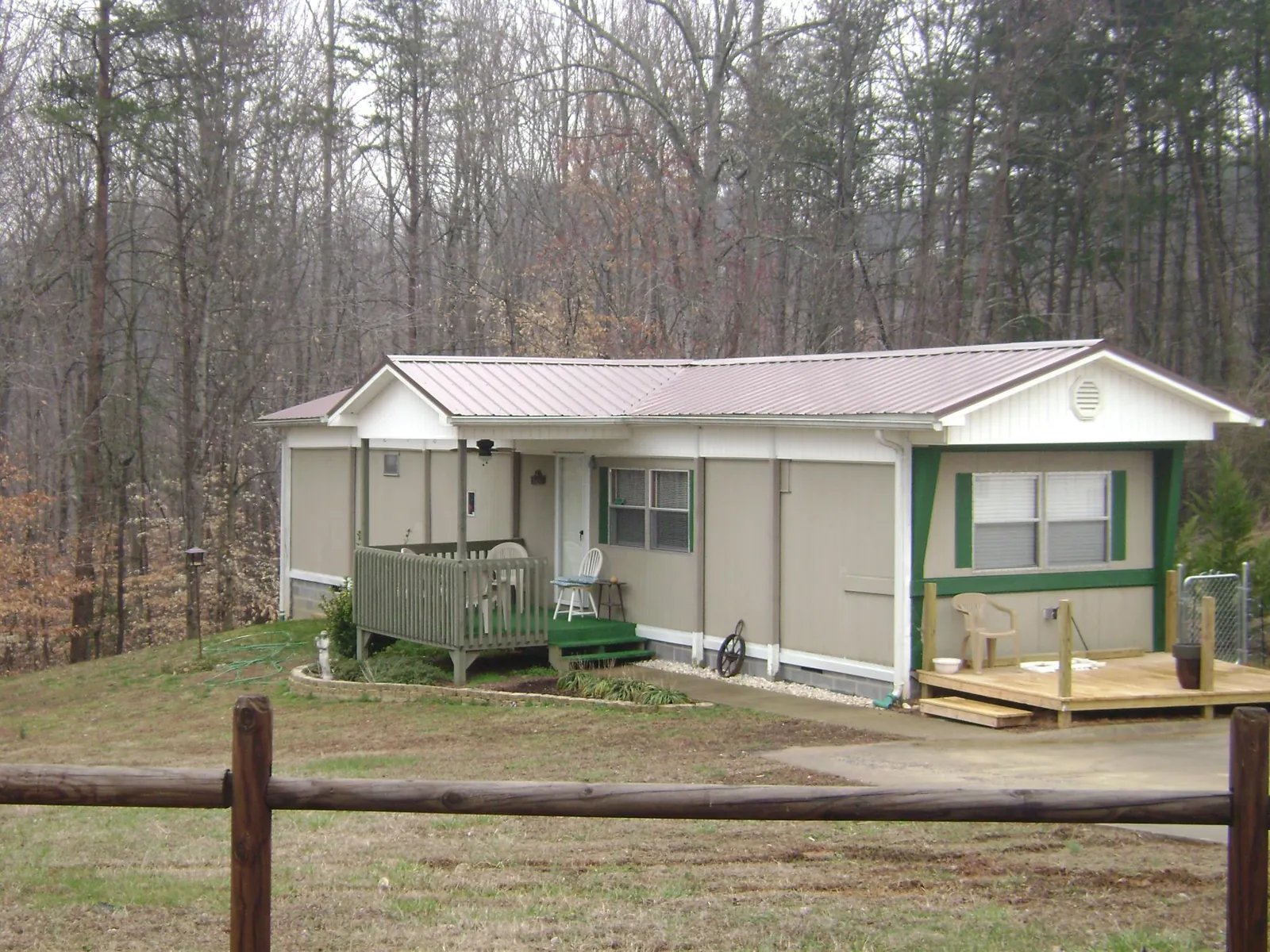 Mauve metal roof on a manufactured home with a new front deck in Millport